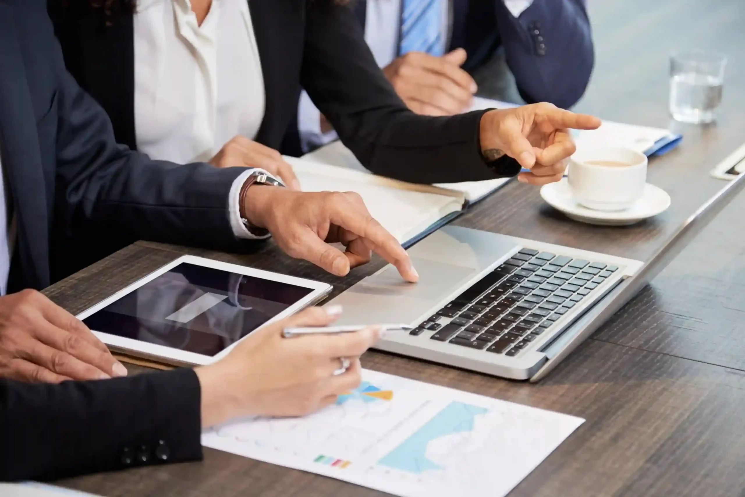 crop-colleagues-using-laptop-table_11zon